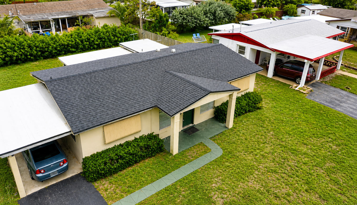 Aerial view of residential home with shingle roof