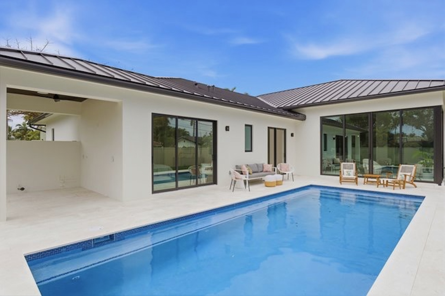 Modern home backyard with pool and metal roof